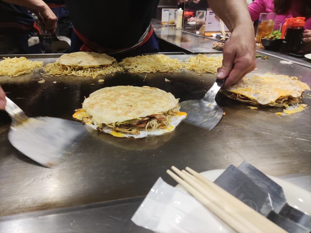 Okonomiyaki cooked on hot plate in japan
